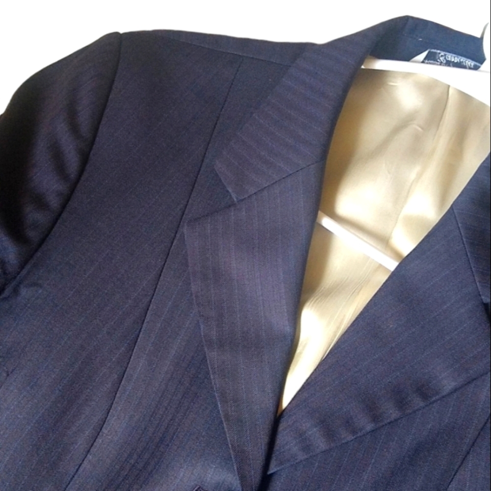 Blazer suit. it reflects 2 shades and is with blue buttons.